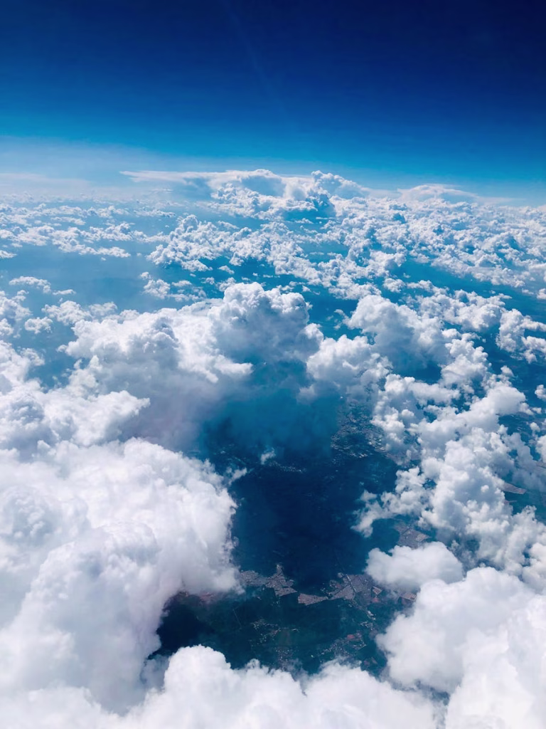 Stunning aerial view of fluffy clouds over Mexico with a clear blue sky.